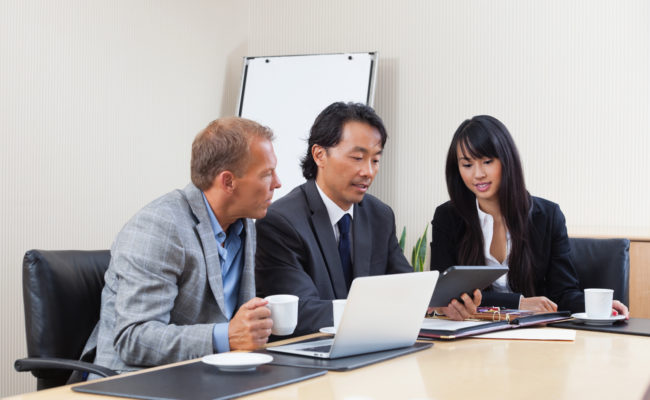 Business people using tablet in meeting